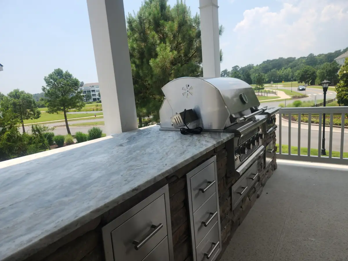 Outdoor kitchen with countertop and bar seating