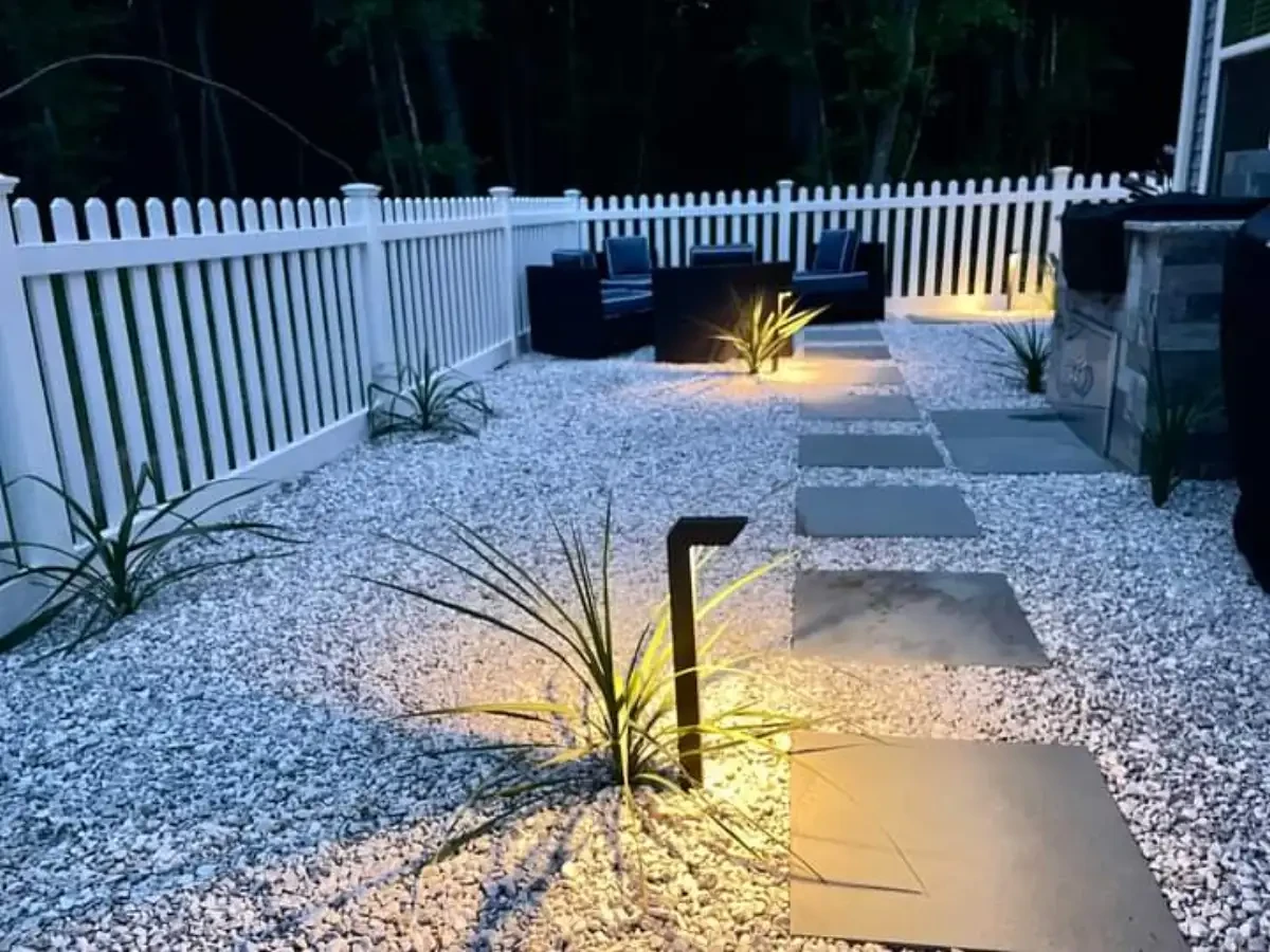 Path lights illuminating stepping stones and planting beds at night